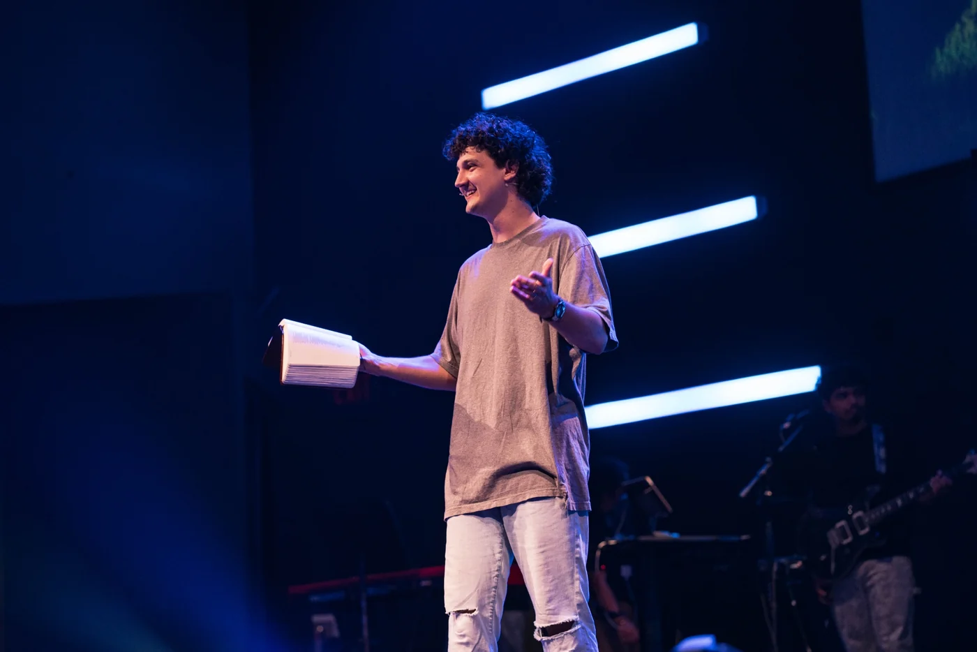 Cayden speaking on stage, seen from the side